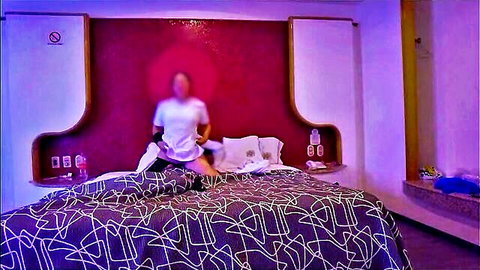 Latina nurse in white top undressing on bed after work