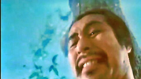 Asian man with long hair smiling intensely underwater in Kung Fu adult video
