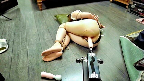 Bound Chinese woman endures BDSM sex machine penetration
