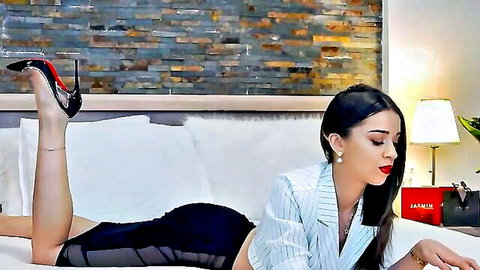 Attractive businesswoman in hot uniform and sexy stilettos posing seductively on cam
