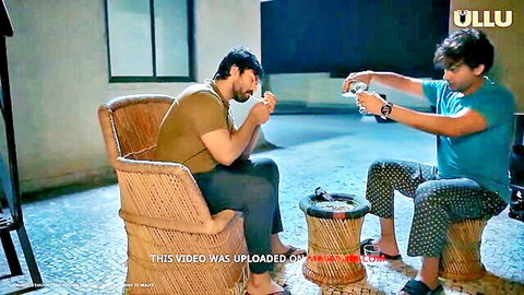 Two Indian men in casual attire sharing drinks in Farebi Yaar 3 Ullu MILF series