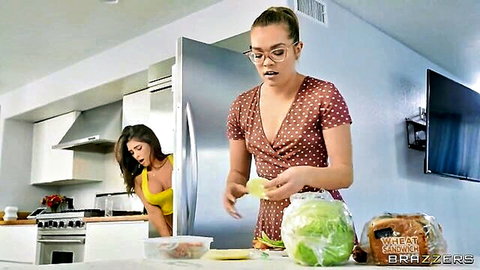 Busty brunette with glasses in polka dot dress holding lettuce in kitchen with girlfriend Brazzers