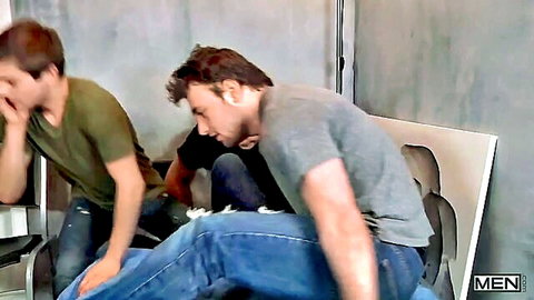 Two fit men in casual clothes intimately comparing their cocks