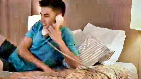 Man on phone in bed from Reality Kings video with ebony star Aryana Adin