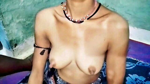 Topless South Asian MILF with big bare tits and erect nipples wearing beaded necklace