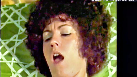 Vintage curly-haired brunette moaning with open mouth in orgasmic pleasure