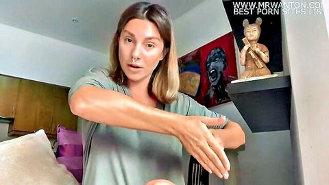 Blonde woman demonstrates fingering technique in clothed sex instruction video