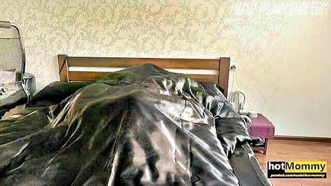 Seductive MILF stepmom under shiny silk sheets, teasing for study