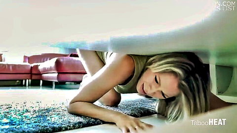Blonde stepmom smiling teasingly under table in threesome scene
