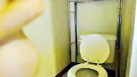Blonde pregnant woman squatting nude over toilet, erotic fetish scene