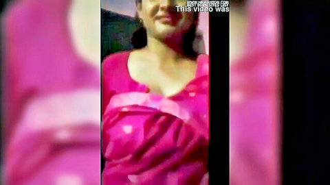 Indian woman in pink saree blouse smiling with cleavage