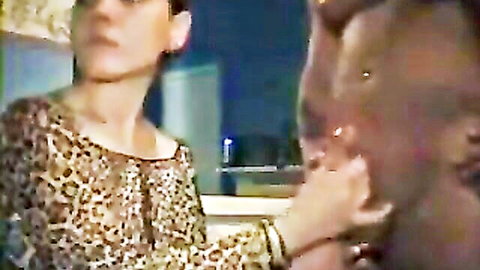 Woman in leopard print top stroking muscular black man's cock backstage