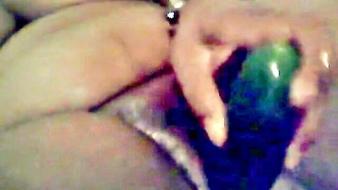 Woman masturbating with cucumber insertion in solo play