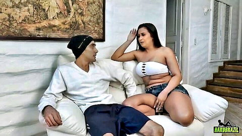 Curvy Latina in tube top and shorts teasing with guy on couch