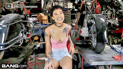 Tattooed Asian babe in pink crop top and denim shorts in garage confession