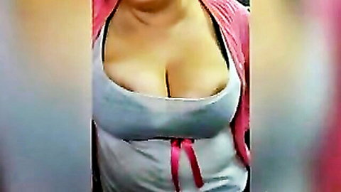 Paola braless in gray tank top showing deep cleavage
