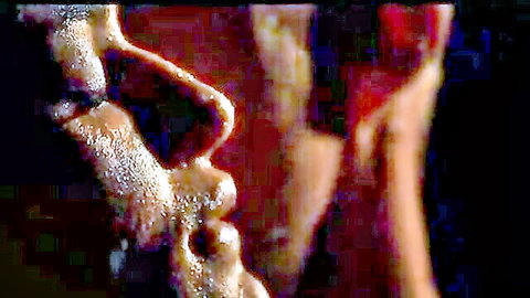 Close-up of bearded man's wet lips and stubble in sensual erotic tease.