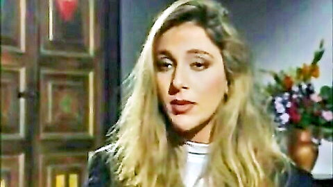 Blonde woman in white turtleneck and blazer, thoughtful pose from La Clinica Della Vergogna