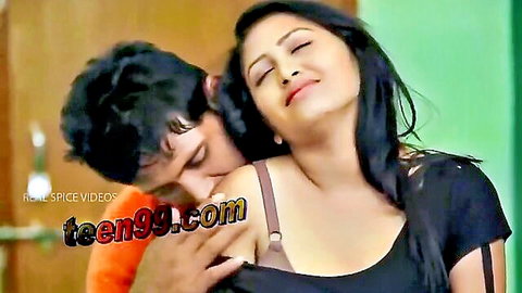 Cute Indian couple in passionate embrace, man kissing woman's neck softly