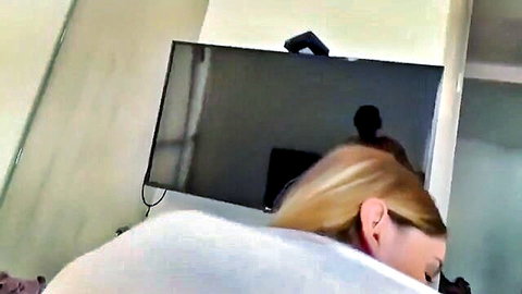 Blonde amateur babe in tight white top teases from behind in POV webcam bedroom view