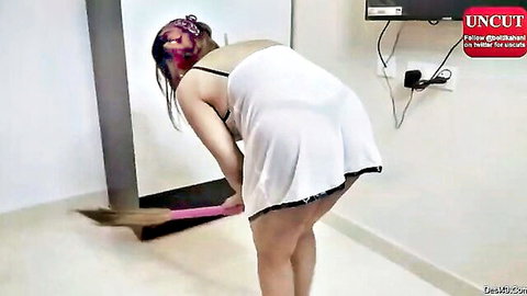 Desi woman in white slip bending over while sweeping, teasing ass view