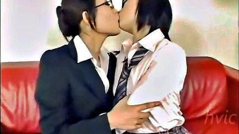 Two Japanese women in uniforms kissing passionately, clothed lesbian scene