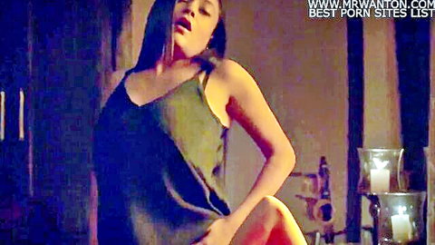 Seductive Indian woman in green slip dress arching back sensually