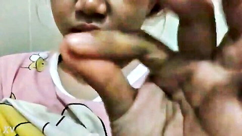Young Asian woman in pink bee pajamas teases with fingers in amateur leaked clip