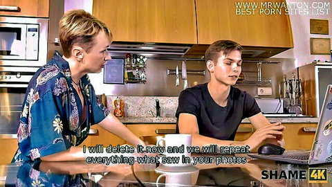 Mature blonde in robe blackmails young stud with laptop photos in kitchen