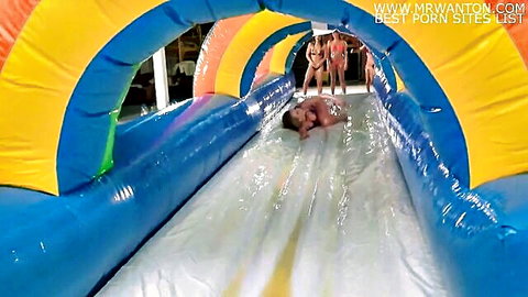 Bikini babes watch nude couple fuck on slippery water slide