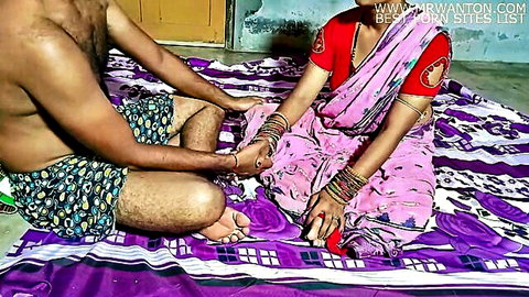 Indian wife in pink saree holds hands with shirtless hubby on bed in amateur homemade tease