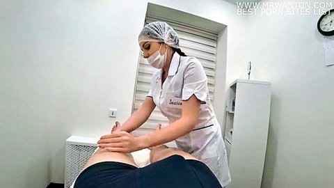 Sexy nurse in uniform massages patient's inner thigh in erotic medical clinic scene