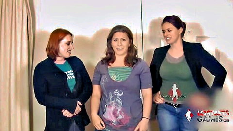 Three clothed women with redhead and brunettes posing smiling at World Poker Games event