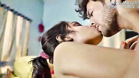 Topless Indian woman with ponytail passionately kisses bearded man while grabbing his bare ass