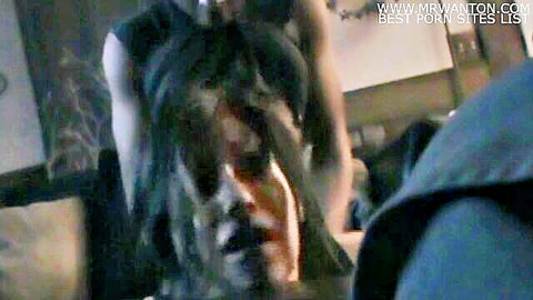 Brunette woman with intense expression in dark blurry room