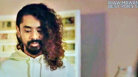 Long-haired bearded South Asian man in hoodie stares pensively in steamy porn preview