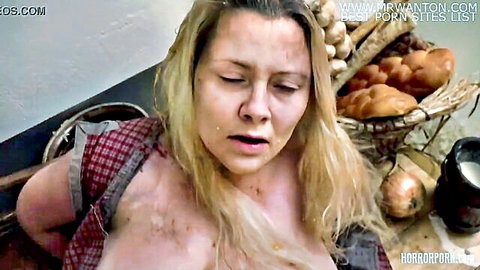 Blonde woman in torn red dress exposing big tits in horror gluttony scene