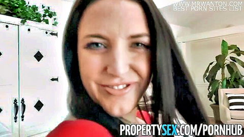 Angela White as busty tenant in red top, smiling at camera