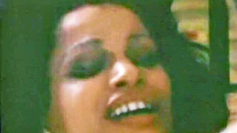 Tanned brunette with heavy makeup screaming in orgasmic ecstasy vintage retro porn closeup