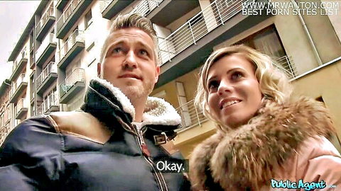 Blonde woman in fur coat smiles with stranger outdoors in Public Agent pickup