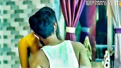 Indian couple in intimate embrace, man kissing woman's neck from behind