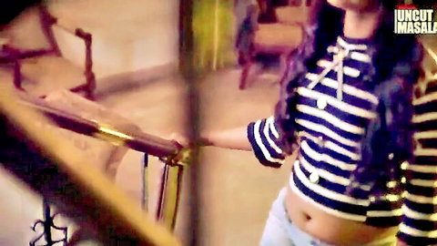 Sexy Indian babe in striped top exposing midriff teasing on stairs