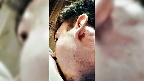 Close-up man with curly hair in steamy sauna oral scene