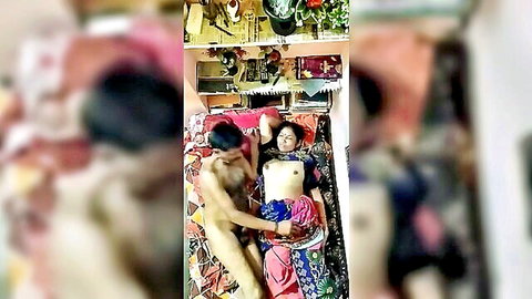 Naked Indian MILF lies with legs spread as nude stud grabs her tits on colorful bed