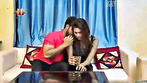 Indian couple intimate neck kiss, man in red shirt embracing woman in black dress