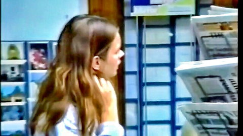 Vintage 90s brunette with long hair in white top, side profile view