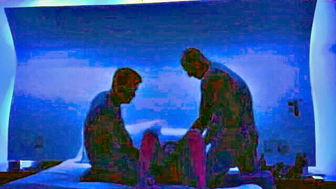 Silhouette MMF threesome with two men flanking a woman in explicit action