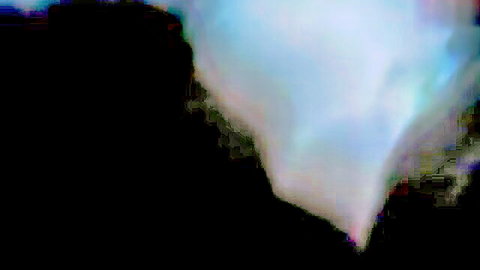 Blurry abstract glowing white cloud shapes on black background