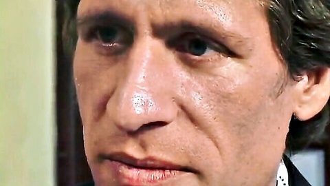 Intense close-up of handsome man's face in suit staring directly at camera