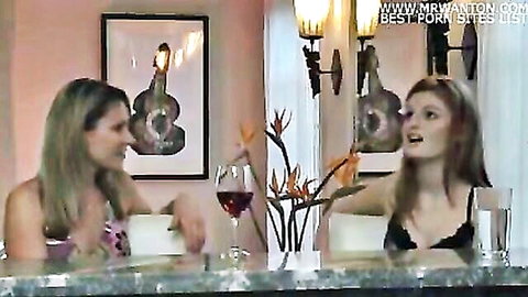 Two busty blondes in sexy lingerie flirting over wine at bar showing deep cleavage
